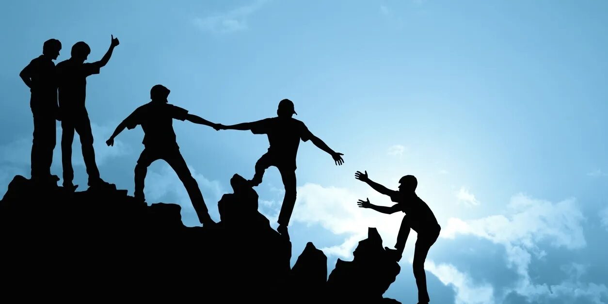 A group of people climbing up the side of a mountain.